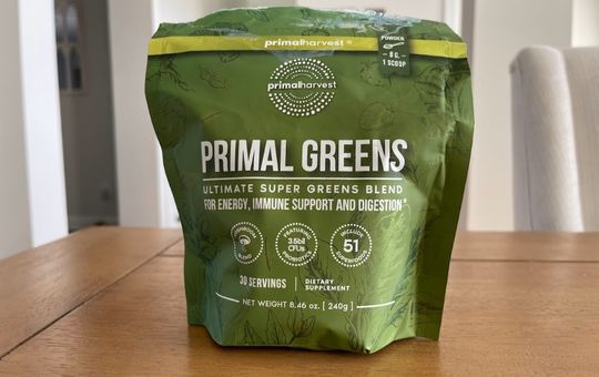 table with a bag of primal greens