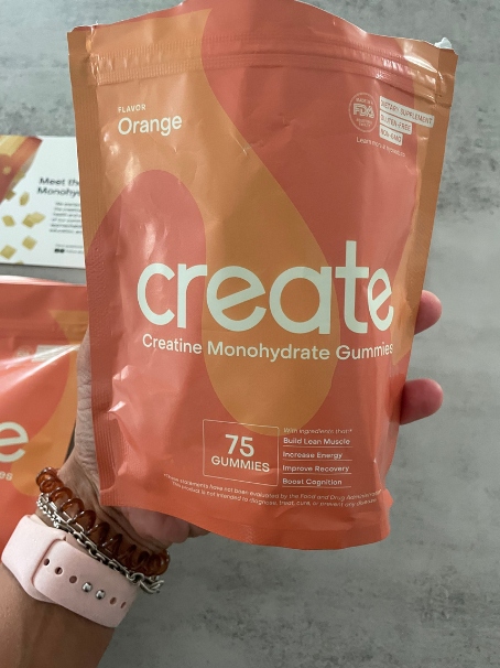 holding the create creatine gummies package