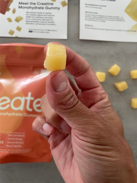 holding a square creatine gummy