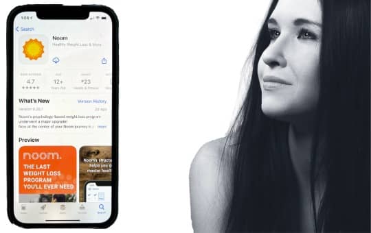 noom app and woman looking at it
