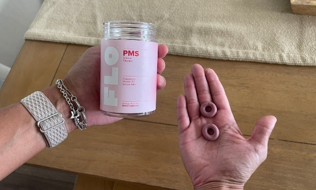 FLO PMS gummies in hand